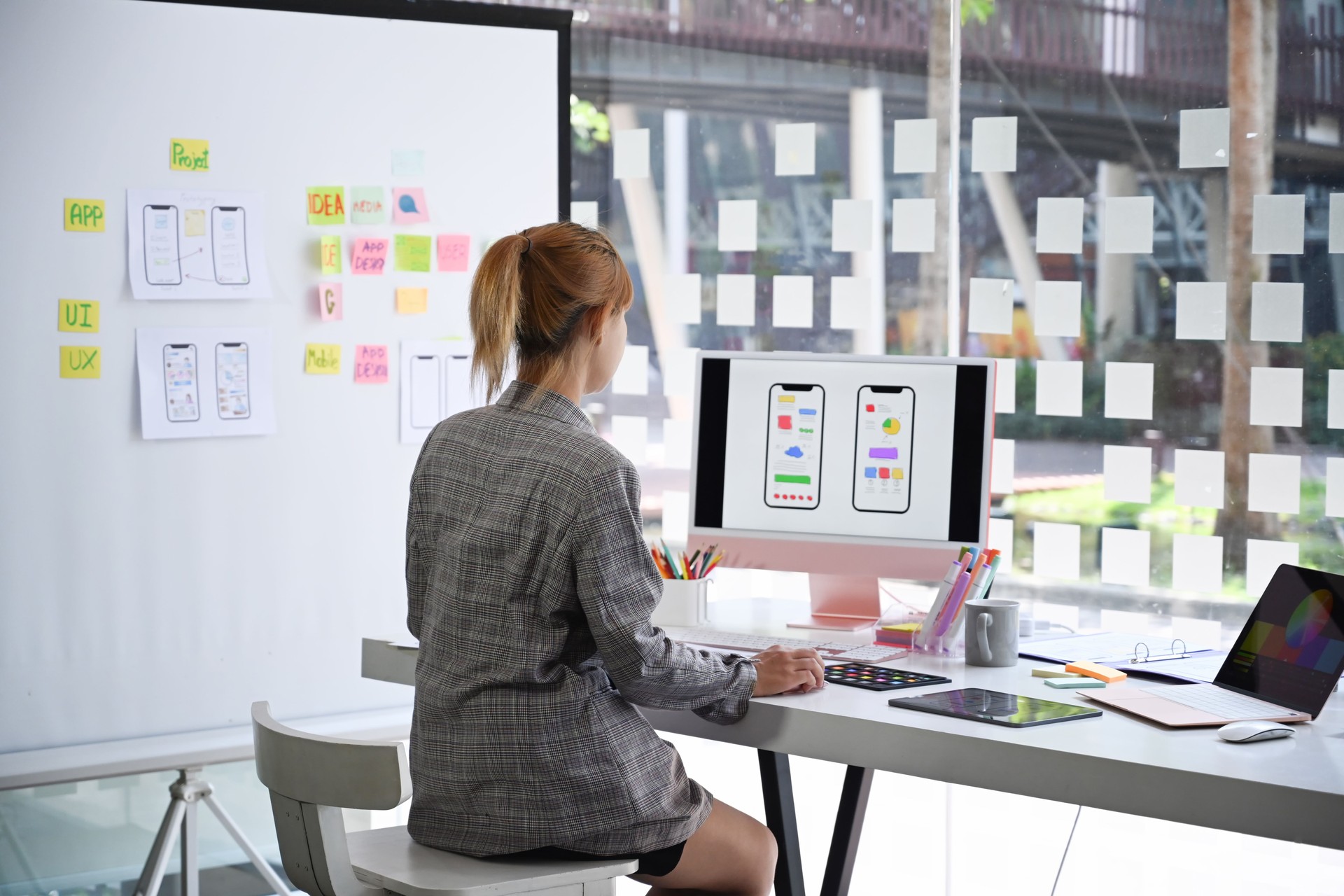 UX designer planning phone app development template layout wireframe design at modern office.